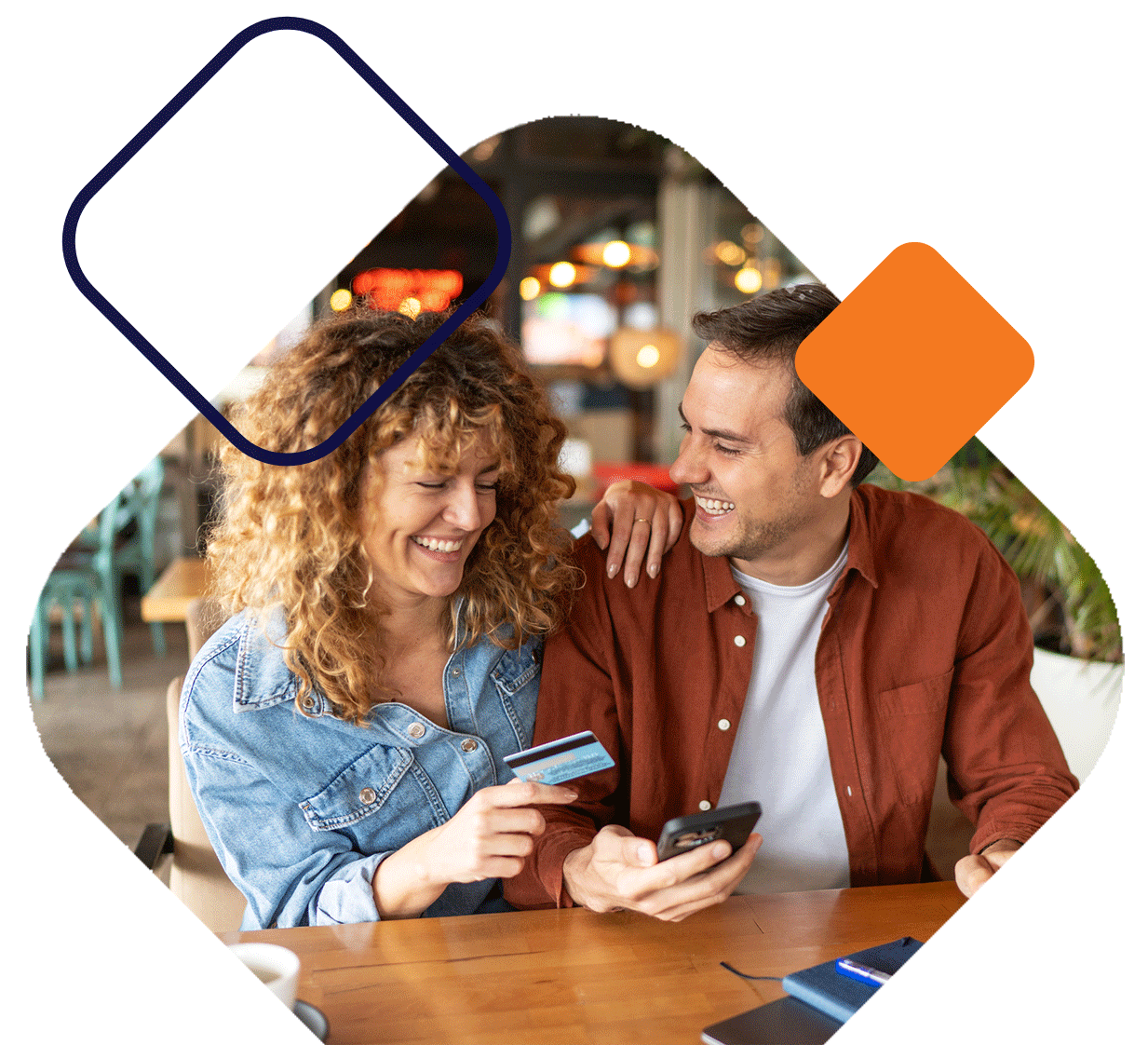 Couple Holding Card And Phone