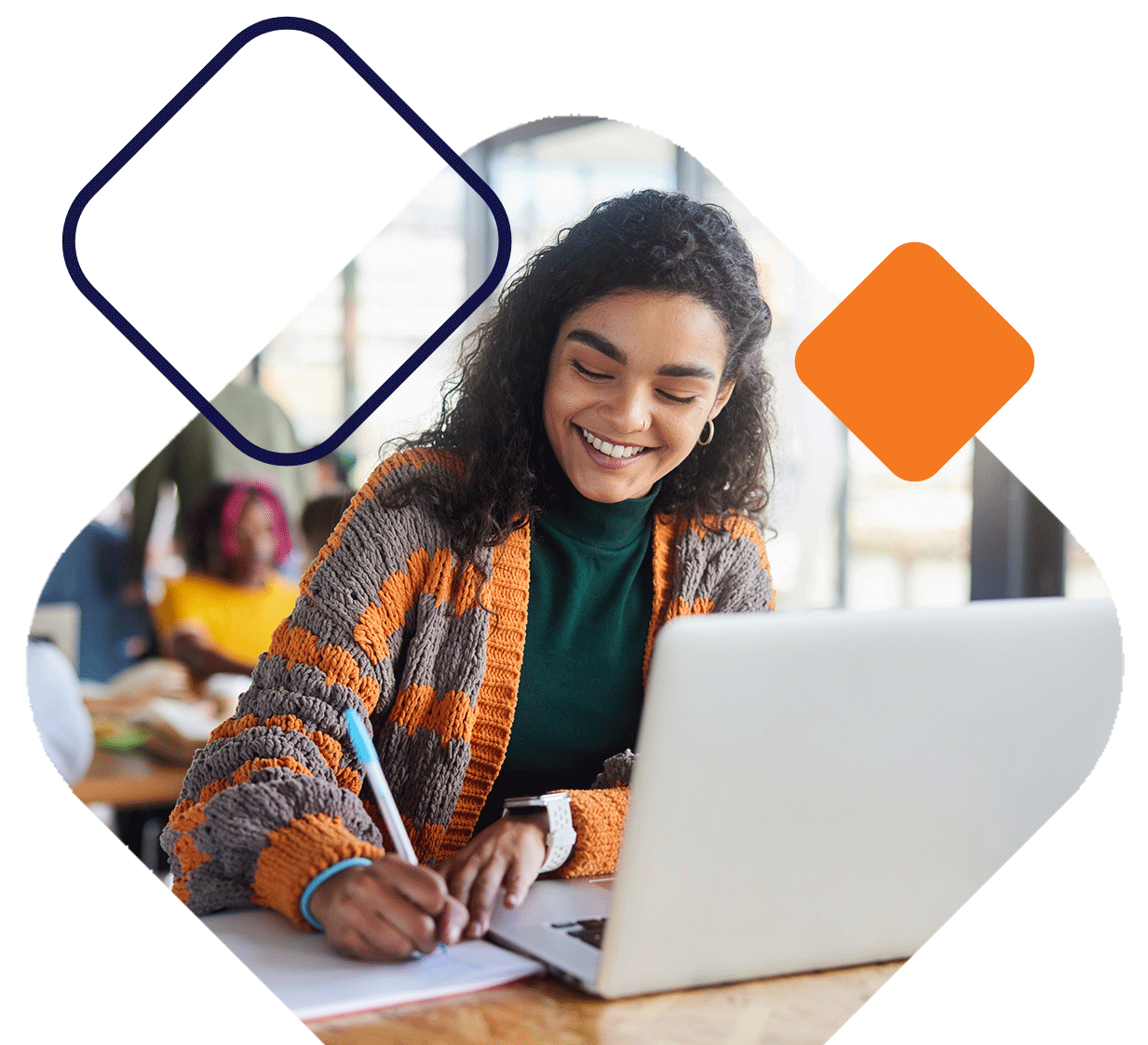 SmilingStudentWritingInNotebookWithLaptop